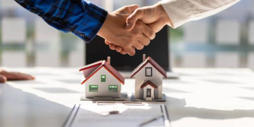 istockphoto-1409298953-612x612 Real estate agents shake hands after the signing of the contract agreement is complete.